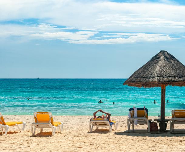 Beach chairs and a cabana on a beach in Cancun.