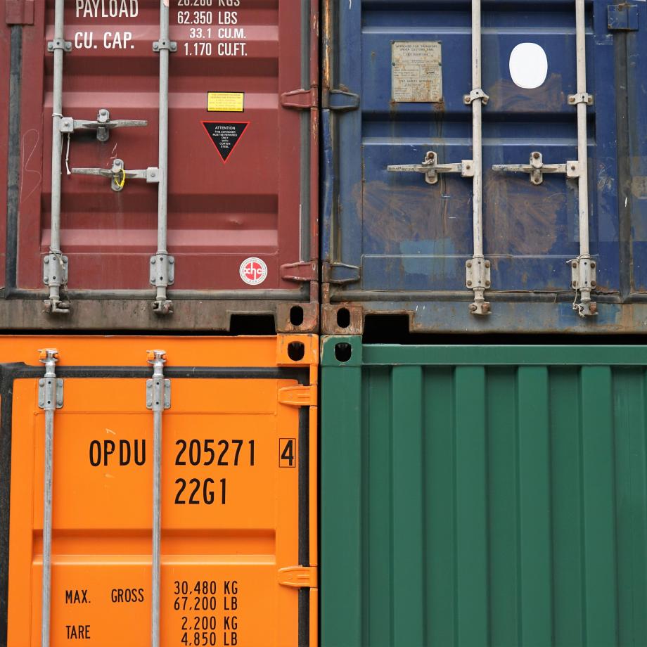 view of 4 different freight containers, all a different color