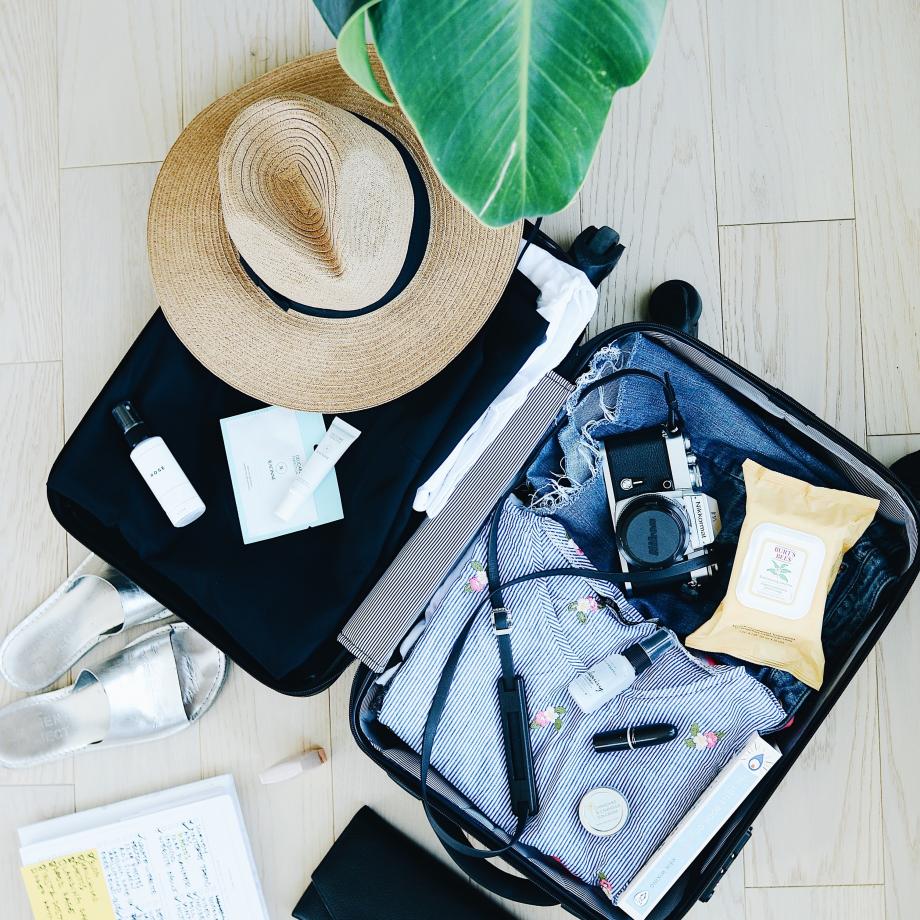 an open suitcase full of items for travel