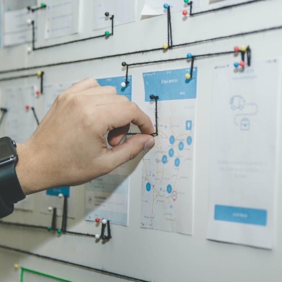 a hand adjusting an idea board