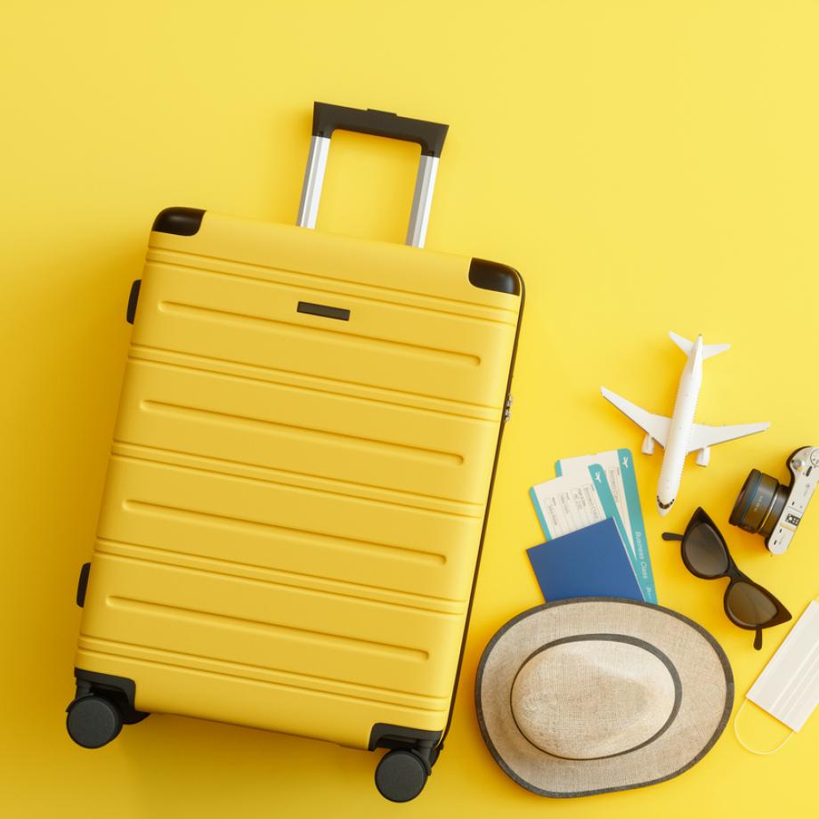 yellow suitcase and travel items