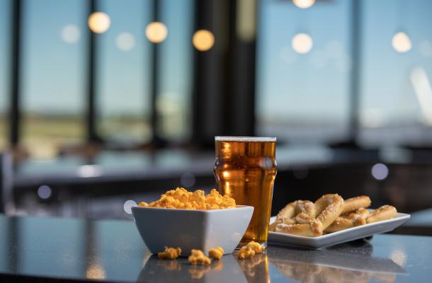 food and beverage on a table with large windows in the background