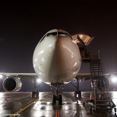an airplane at the airport at night